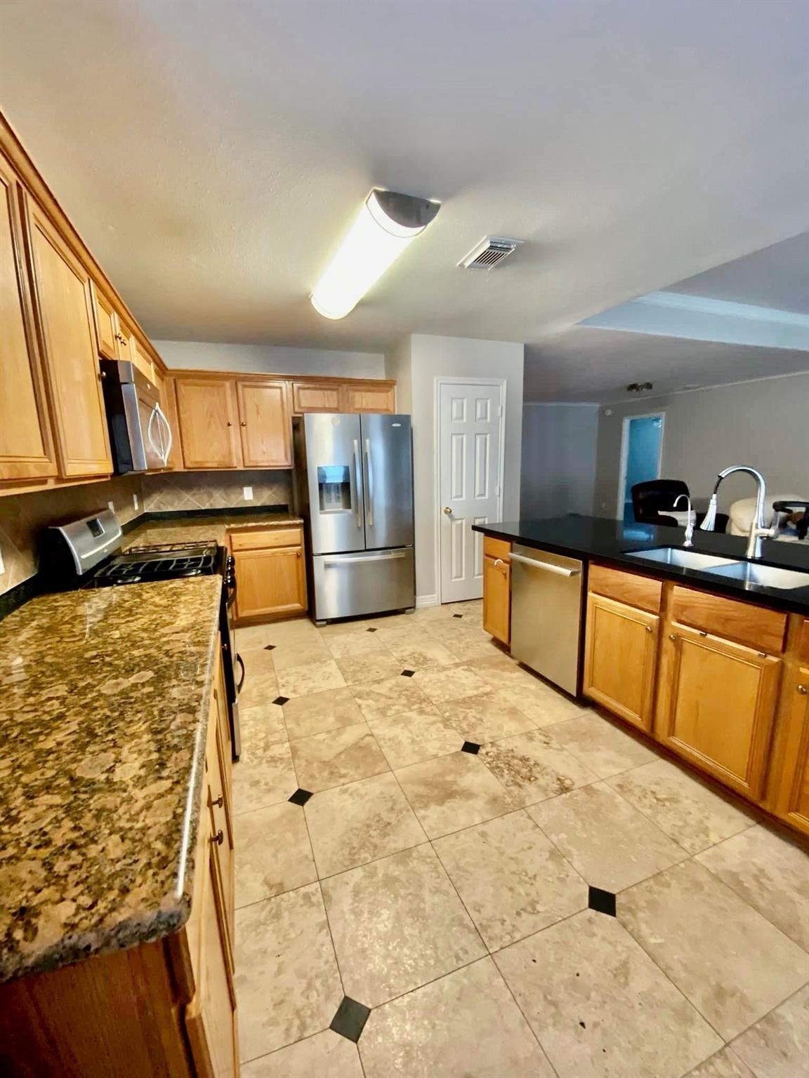21127 Gate View Drive Houston, TX 77073 - Photo 16 of 18 a kitchen with stainless steel appliances kitchen island granite countertop a refrigerator and stove