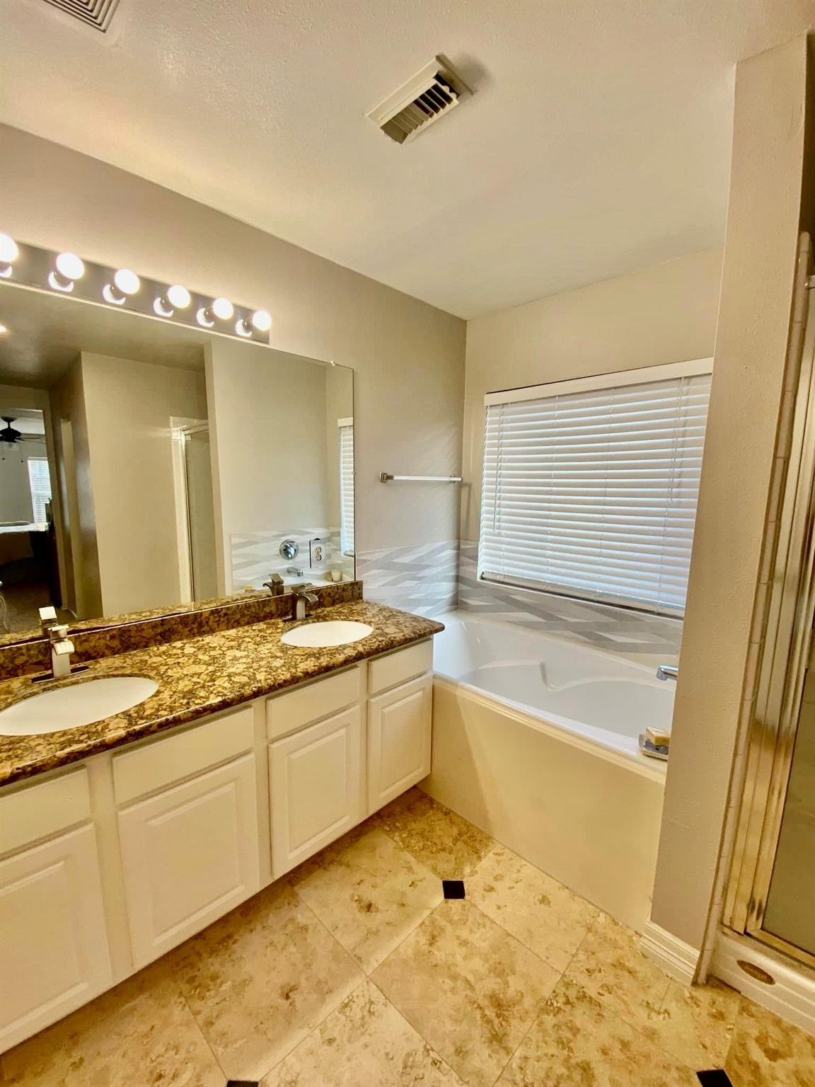 21127 Gate View Drive Houston, TX 77073 - Photo 8 of 18 a bathroom with a granite countertop sink and a bathtub