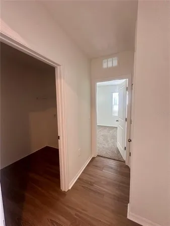 wooden floor in a hall with an empty room