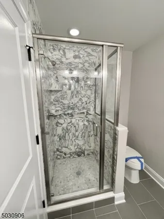 a bathroom with a shower and a toilet