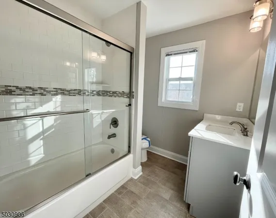 a bathroom with a tub sink and mirror