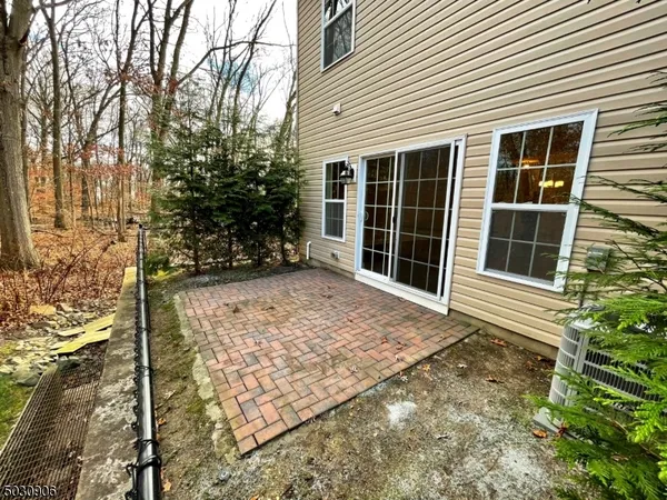 a view of house with backyard and sitting area