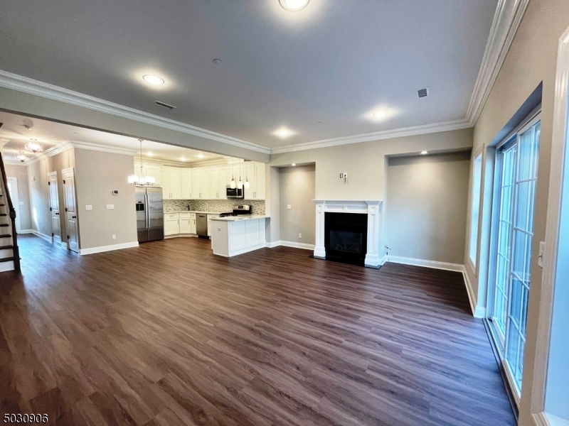 7 North Ridge Circle East Hanover, NJ 07936 - Photo 3 of 25 a view of a empty room with wooden floor and a fireplace