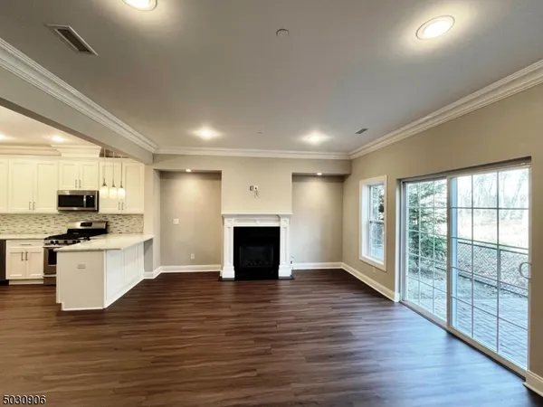 a view of kitchen with sink a refrigerator and a stove top oven