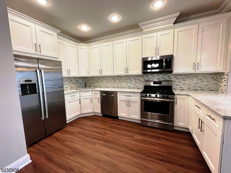7 North Ridge Circle East Hanover, NJ 07936 - Photo 5 of 25 a kitchen with stainless steel appliances granite countertop a stove a refrigerator and a microwave