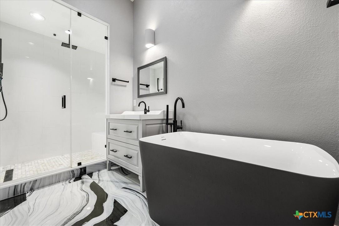 1009 Highknoll Lane Georgetown, TX 78628 - Photo 20 of 38 a bed room with a bed and a dresser