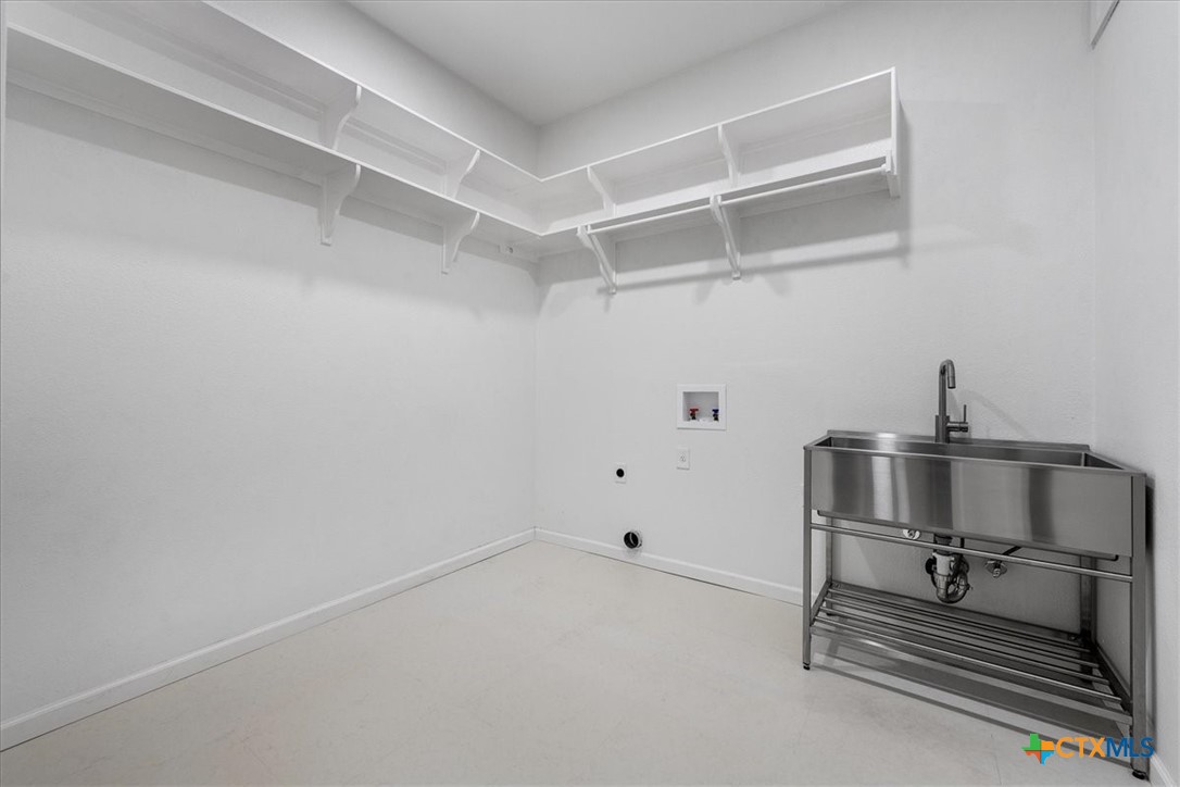 1009 Highknoll Lane Georgetown, TX 78628 - Photo 22 of 38 a room with a bench and white walls