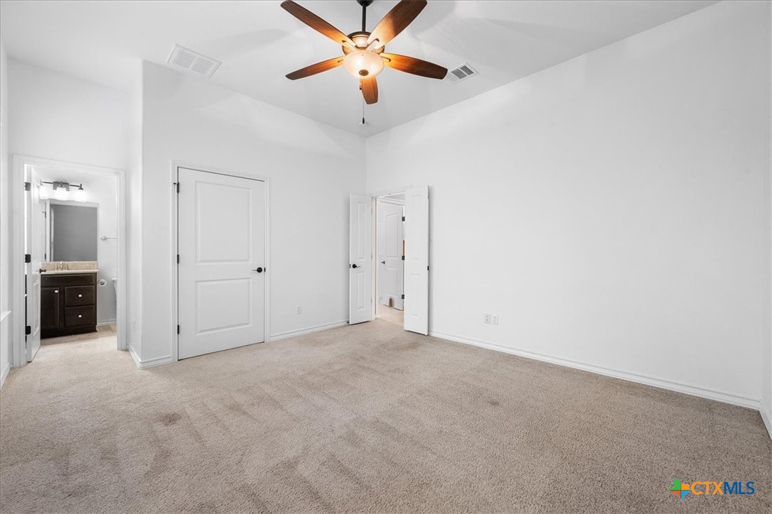 1009 Highknoll Lane Georgetown, TX 78628 - Photo 23 of 38 an empty room with closet and a ceiling fan