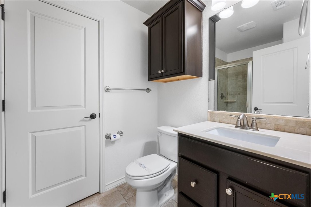 1009 Highknoll Lane Georgetown, TX 78628 - Photo 31 of 38 a bathroom with a sink a toilet and shower