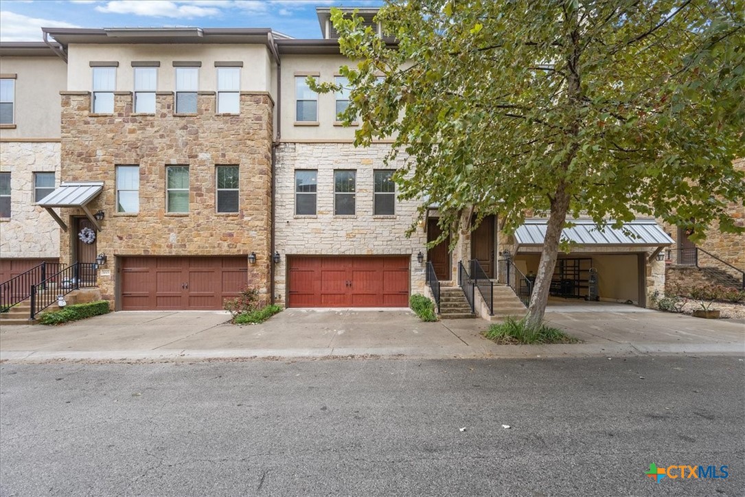 1009 Highknoll Lane Georgetown, TX 78628 - Photo 36 of 38 a front view of a house with a yard and garage