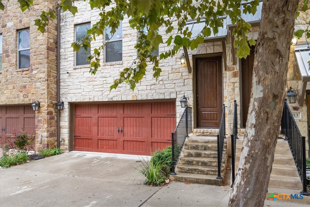 1009 Highknoll Lane Georgetown, TX 78628 - Photo 4 of 38 a front view of a house with a garden