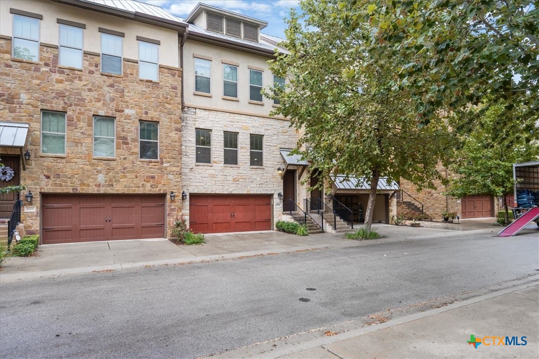 1009 Highknoll Lane Georgetown, TX 78628 - Photo 5 of 38 a front view of a house with a yard and garage