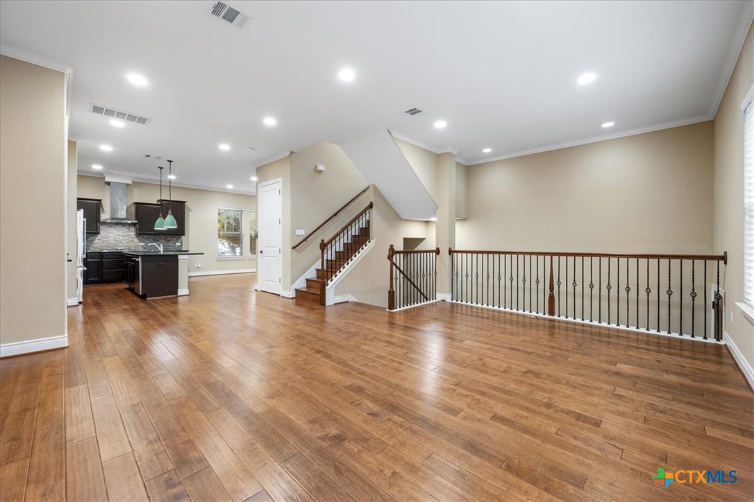 1009 Highknoll Lane Georgetown, TX 78628 - Photo 6 of 38 a view of kitchen with furniture and wooden floor