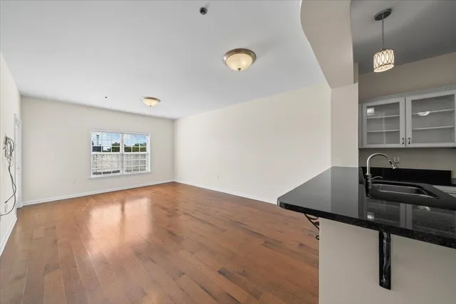 a view of kitchen with sink and wooden floor