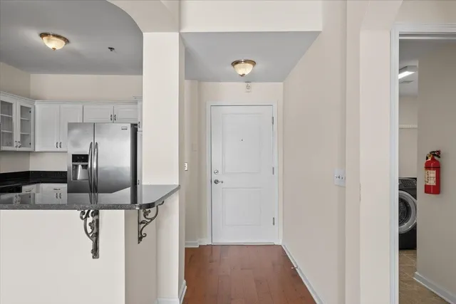 a view of a hallway with a refrigerator