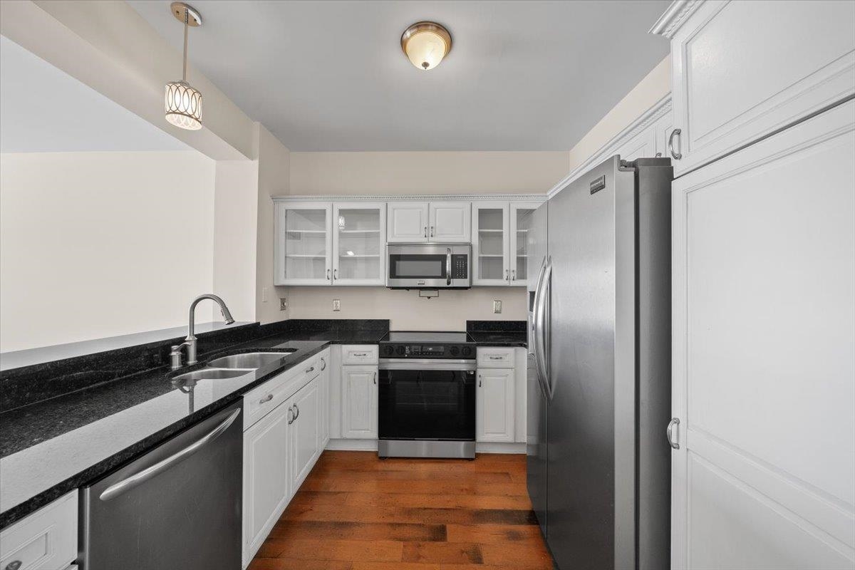 665 Tennessee Street, Unit 411 Memphis, TN 38103 - Photo 8 of 29 a kitchen with stainless steel appliances granite countertop a sink stove and refrigerator