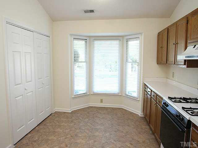 5809 Edgebury Road Raleigh, NC 27613 - Photo 5 of 12 a kitchen with a stove and a sink