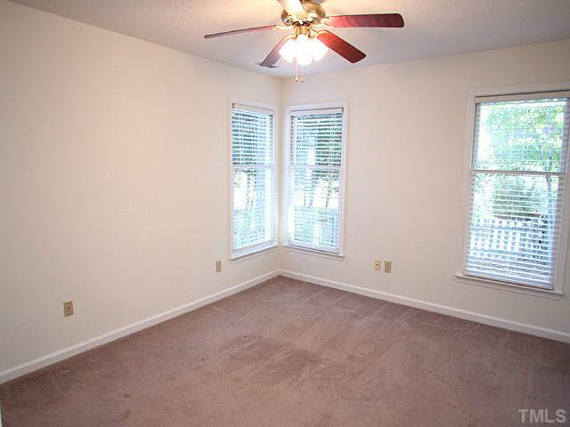 5809 Edgebury Road Raleigh, NC 27613 - Photo 8 of 12 an empty room with windows and fan