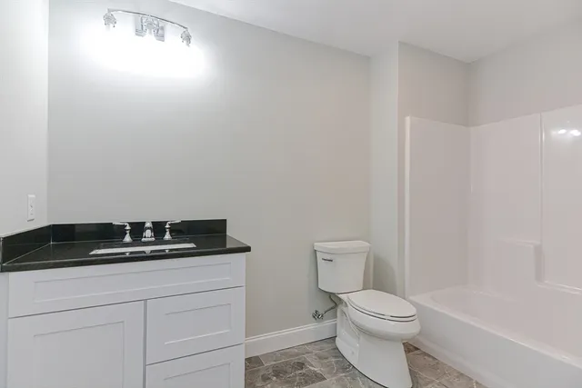 a bathroom with a toilet a sink and bathtub