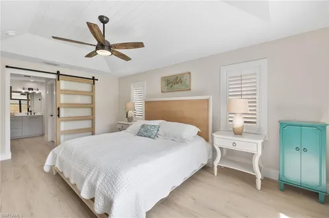 a bedroom with a bed and a chandelier