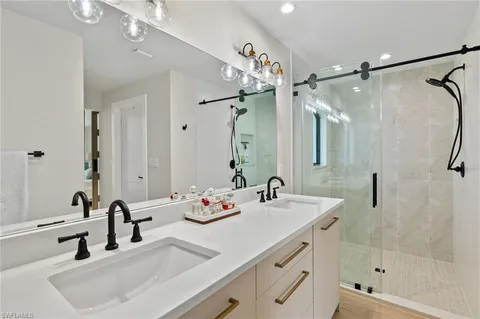 a bathroom with a sink double vanity and shower