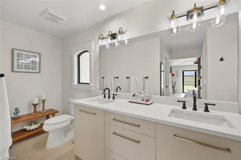 a bathroom with a sink double vanity and a mirror