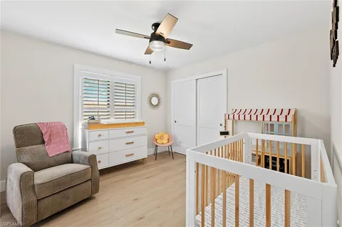 a bedroom with furniture and a large window