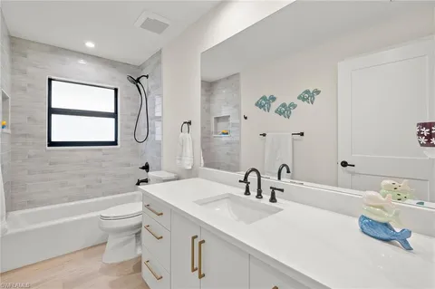 a bathroom with a sink a toilet and a bathtub