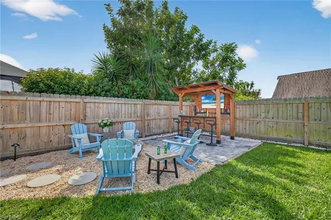 a view of a chairs and table in backyard