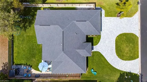 an aerial view of a house with a swimming pool