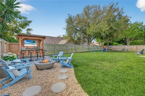 a view of a backyard with sitting area and furniture