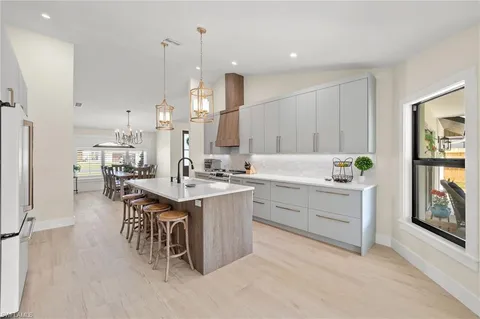 a kitchen with a sink stove and cabinets