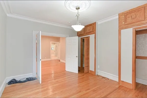 a view of a room with wooden floor and door
