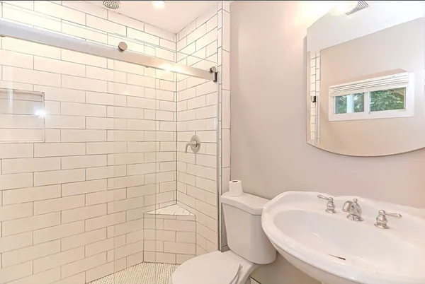 a bathroom with a sink toilet and shower