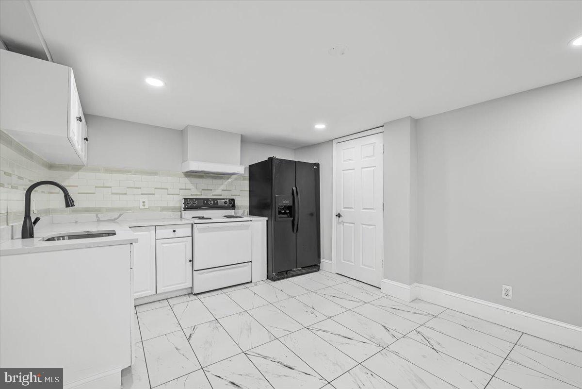 9112 Annapolis Road Lanham, MD 20706 - Photo 29 of 41 a kitchen with white cabinets and refrigerator