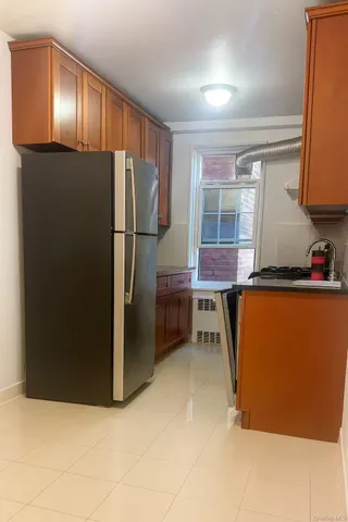 a kitchen with stainless steel appliances a refrigerator and a cabinets