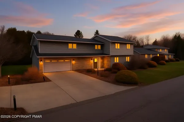 a front view of a house with a yard and garage