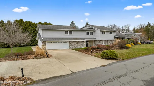 a kitchen with stainless steel appliances granite countertop a refrigerator a sink and a stove