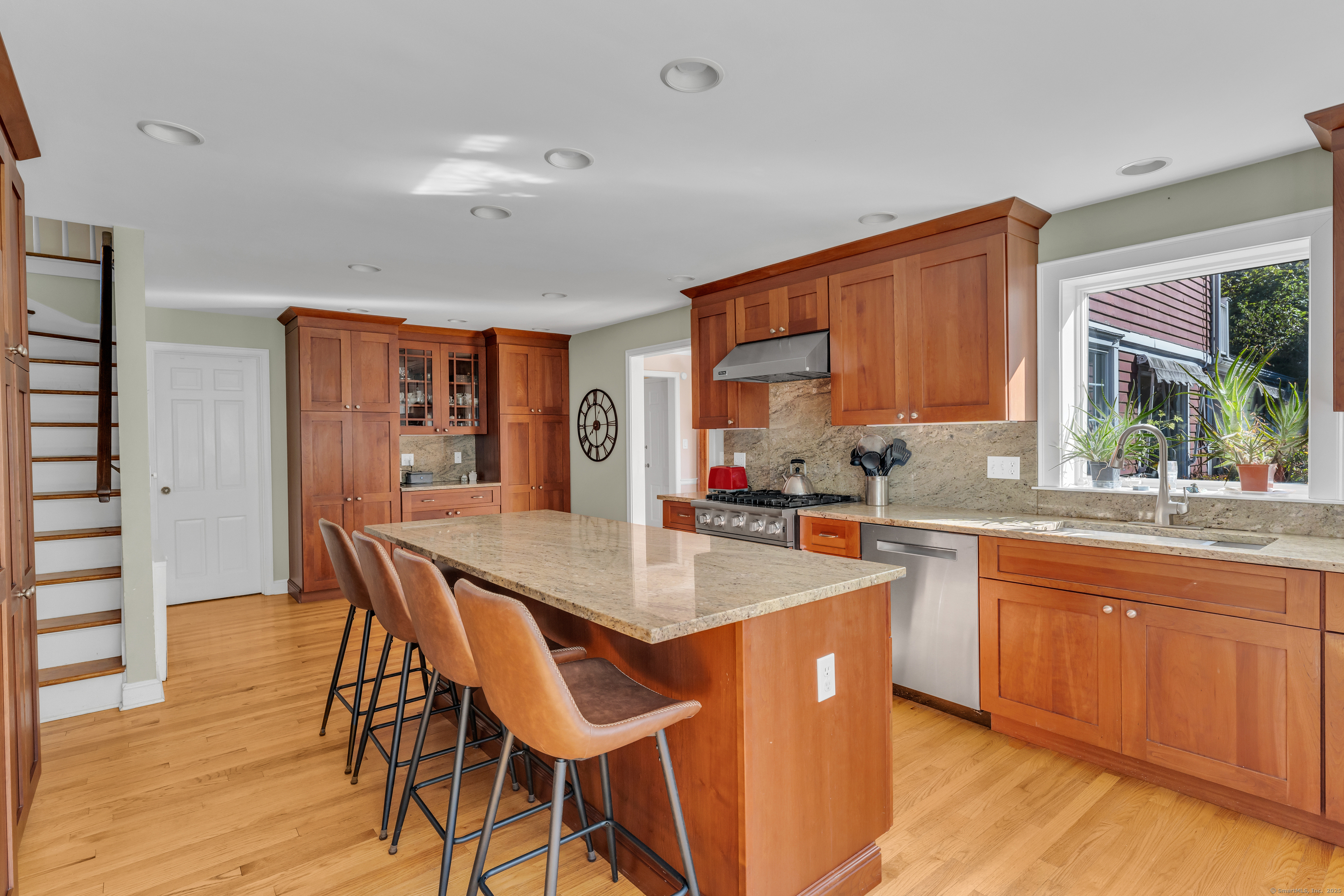 1060 Ridge Road Hamden, CT 06517 - Photo 17 of 40 a dining hall with stainless steel appliances granite countertop a kitchen island a stove a table and chairs
