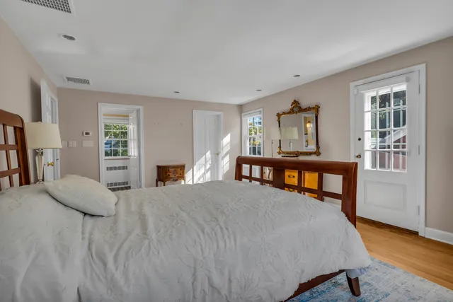 a bedroom with a bed and a large window