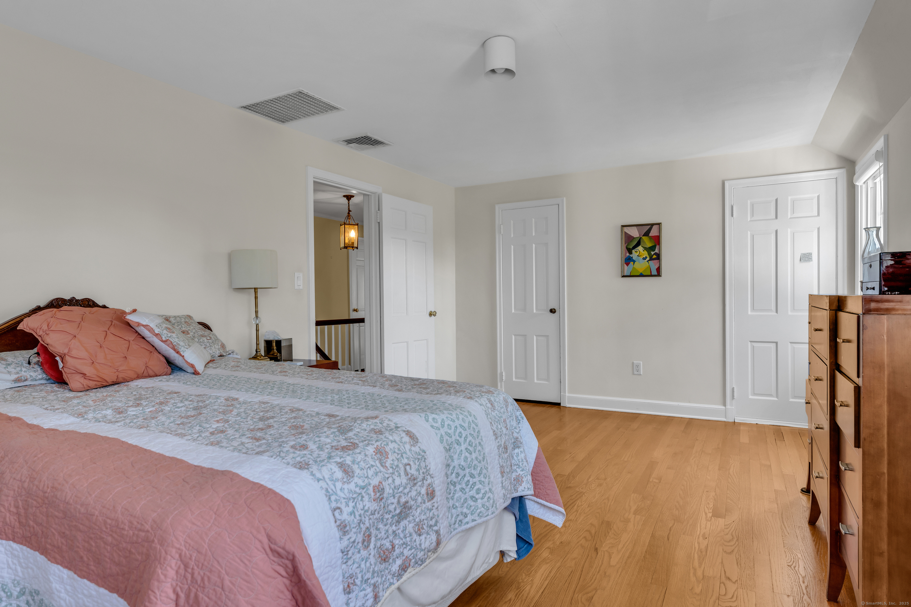 1060 Ridge Road Hamden, CT 06517 - Photo 29 of 40 a bedroom with a bed and a flat tv screen on dresser