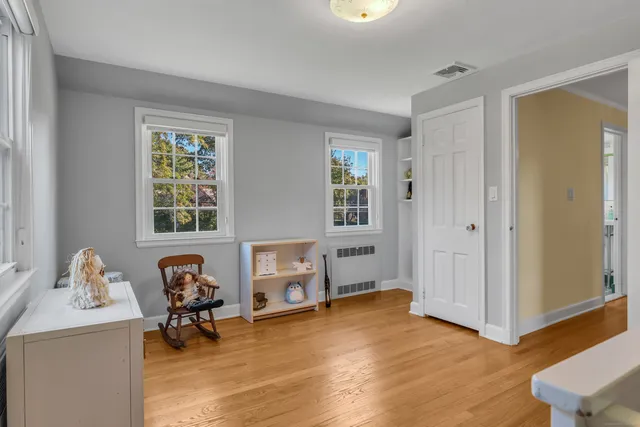 a view of a livingroom with workspace and a window