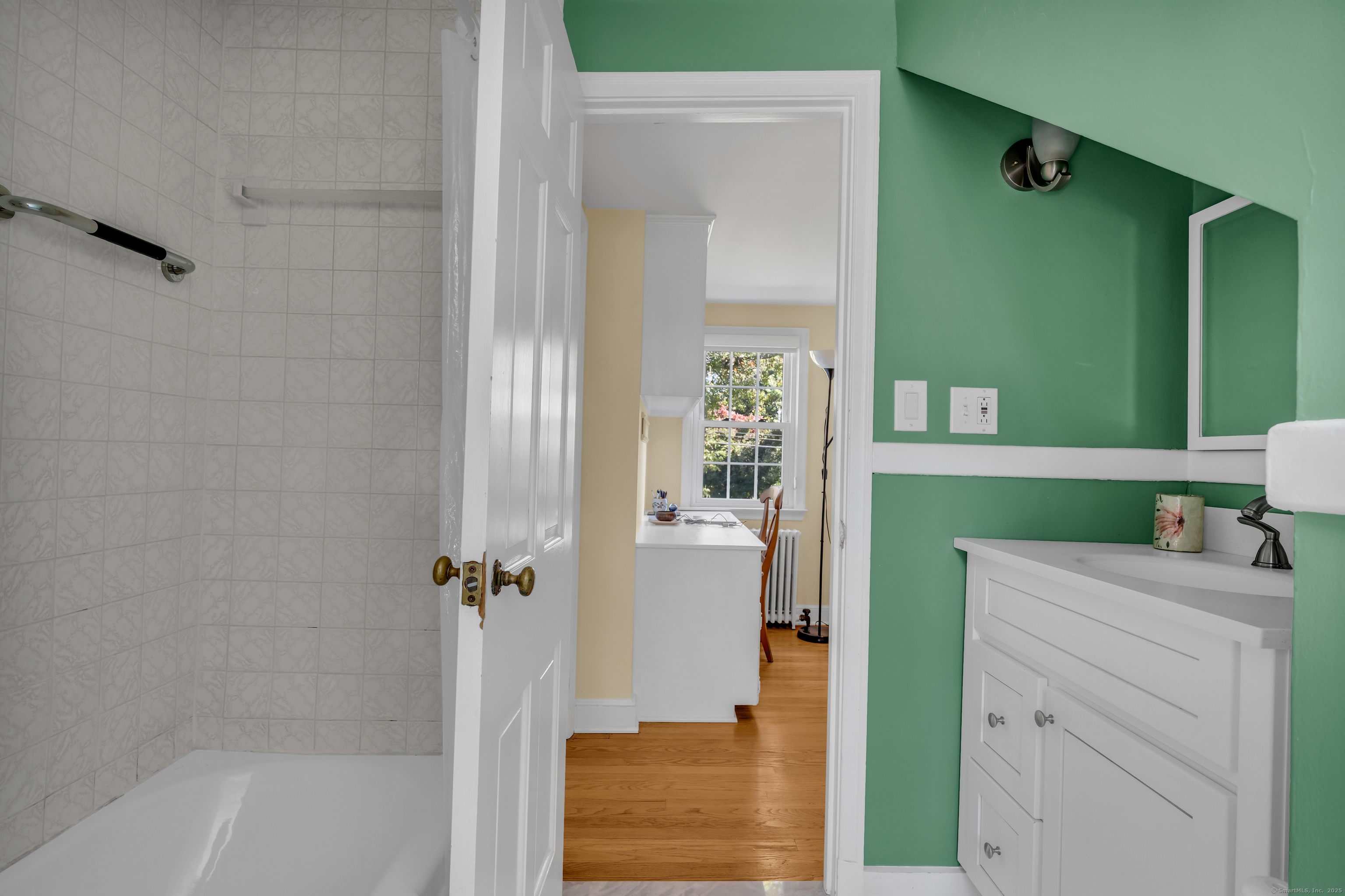 1060 Ridge Road Hamden, CT 06517 - Photo 34 of 40 a bathroom with a bathtub sink and mirror