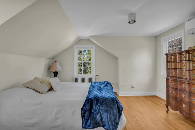 a bed sitting in a bedroom next to a window