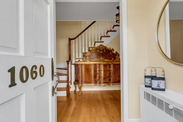 a view of entryway and hall with wooden floor