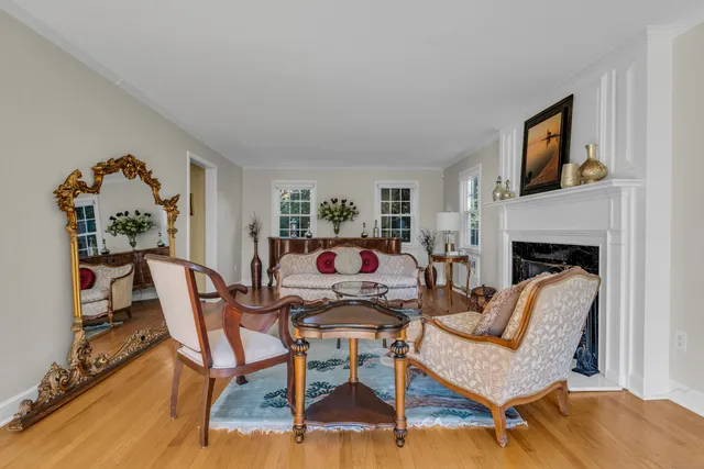 a living room with furniture a fireplace and a window