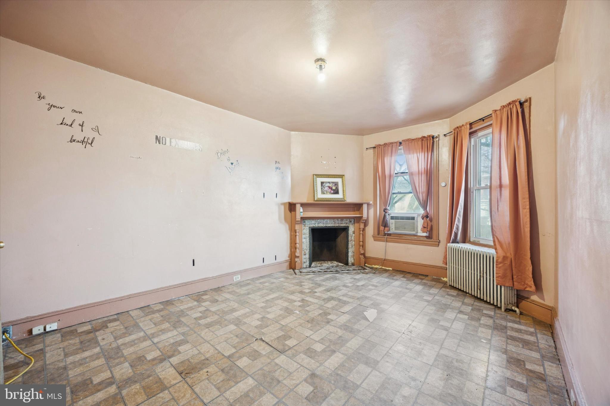 5124 Newhall Street Philadelphia, PA 19144 - Photo 20 of 35 a view of an empty room with a fireplace and a window
