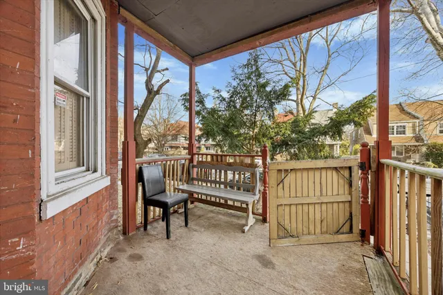 a view of a porch with wooden floor and furniture