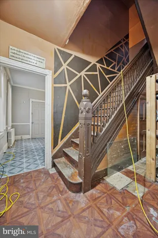 a view of entryway livingroom and hall with wooden floor