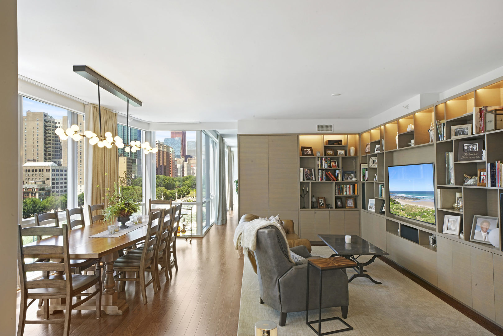 1201 South Prairie Avenue, Unit 601 Chicago, IL 60605 - Photo 16 of 52 a living room with furniture a flat screen tv and a floor to ceiling window